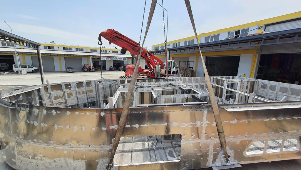Steel block construction yard — crane lifting hull components